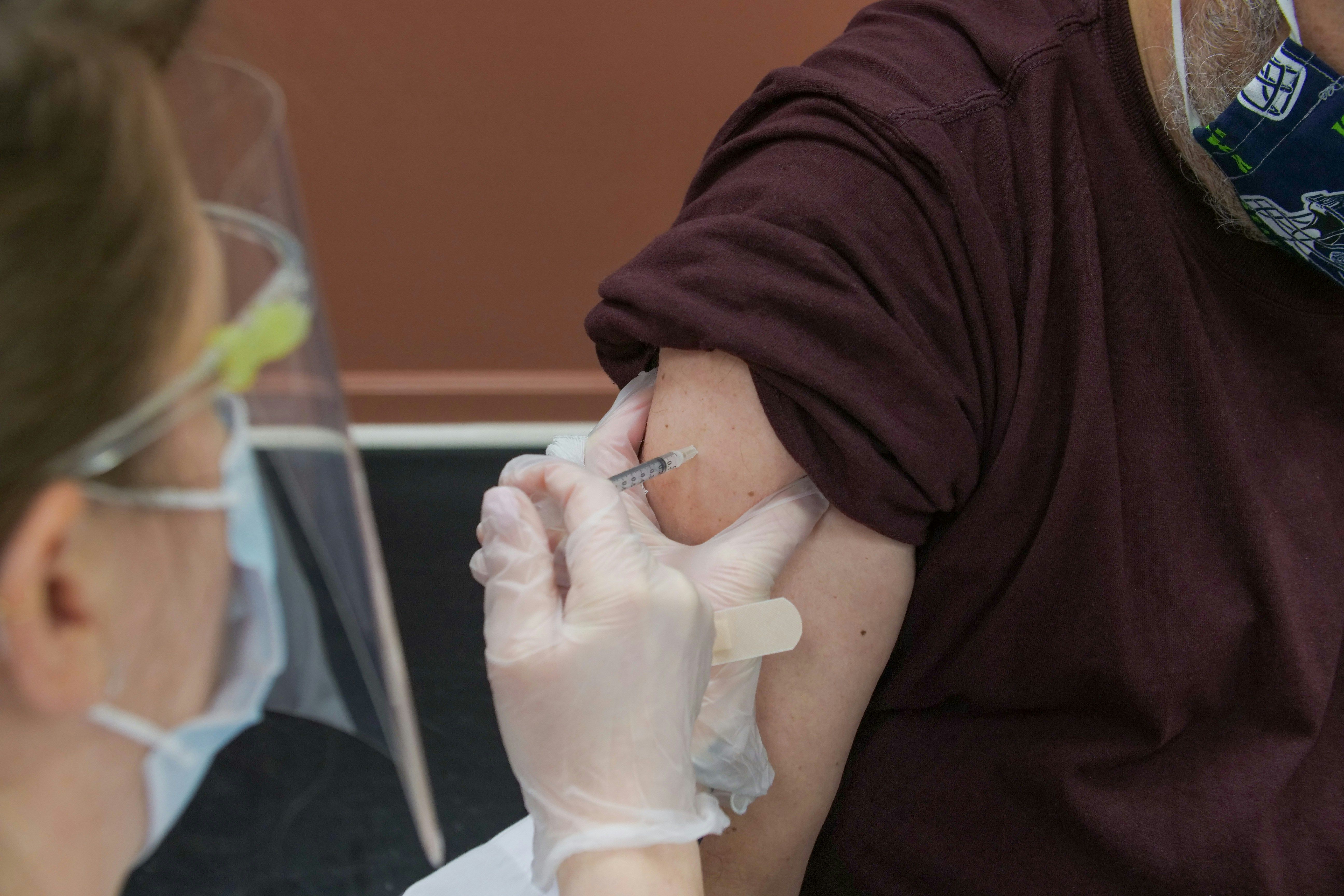 nurse administrating shot into arm 